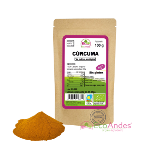 Bolsa de 100g de Cúrcuma en polvo de la marca EcoAndes. El envase es de papel kraft con ventana transparente que muestra el contenido, etiqueta frontal con información nutricional, certificaciones ecológicas, sin gluten y sello de "envasado artesanal".