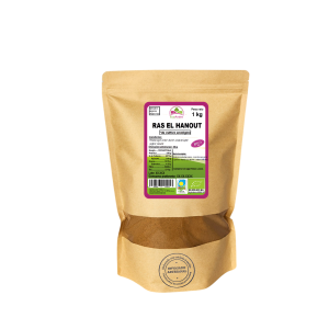 Bolsa de 1kg de Ras el hanout en polvo de la marca EcoAndes. El envase es de papel kraft con ventana transparente que muestra el contenido, etiqueta frontal con información nutricional, certificaciones ecológicas, sin gluten y sello de "envasado artesanal".